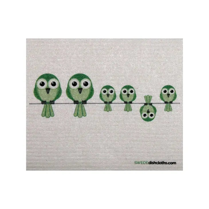 Image of white Swedish dishcloth white green birds of various sizes sitting on a wire.
