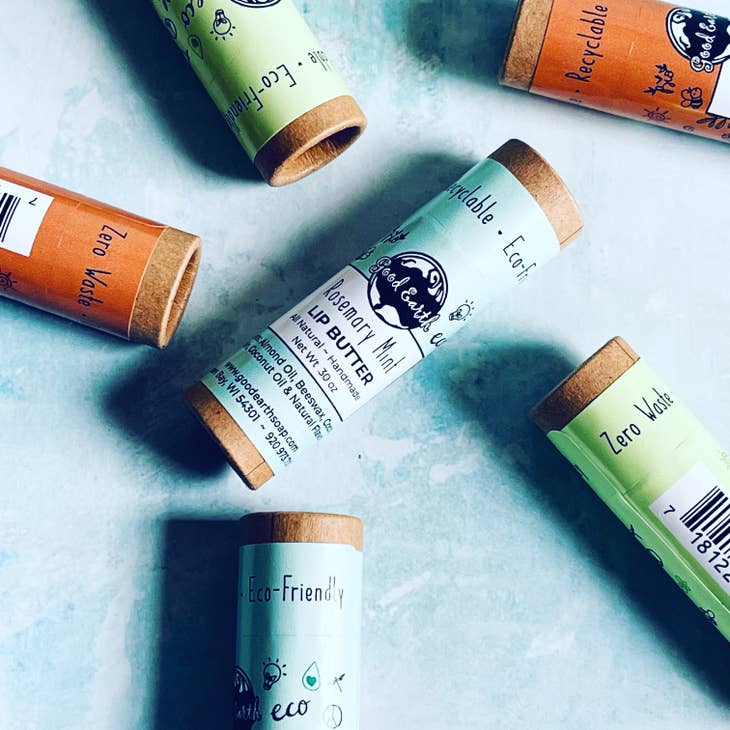 image of various lip butters scattered on table showing product packaging.