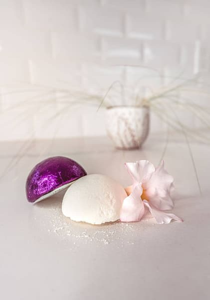 image of unwrapped shower steamer, and one wrapped in purple foil