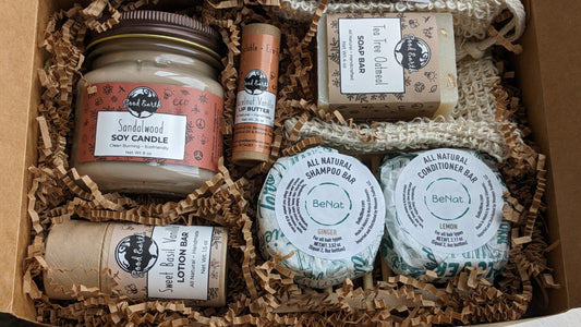 image of Six eco-friendly products bundled to make the perfect gift for anyone. (Scents and flavors with vary based on availablity.) Clean burning soy candle in recyclable mason jar, zero waste shampoo and conditioner bars with bamboo tray, natural soap bar with machine washable soap saver bag that is soft enough to use as a wash cloth and compostable at the end of its life, natural eco-tube lotion bar, and a natural eco-tube lip balm. 