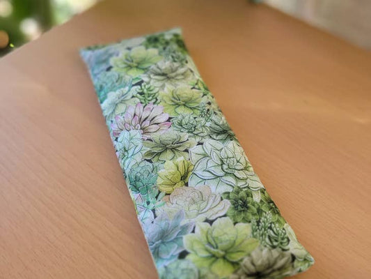 Image of weighted hot and cold eye pillow with succulent print fabric.