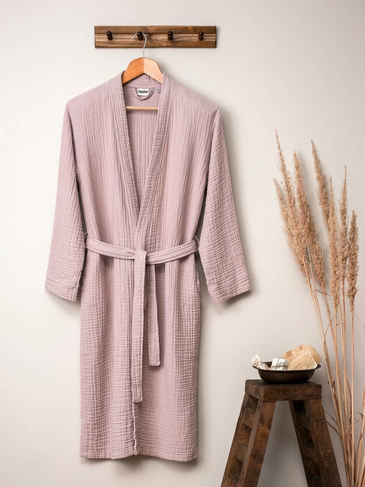 image of rose colored muslin cotton robe hanging on a hanger