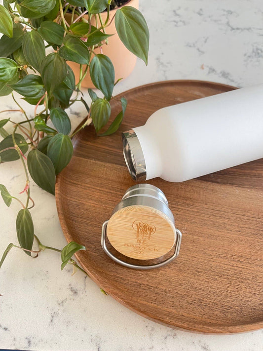 image of white stainless steal water bottle with bamboo and stainless lid, twist on lid.