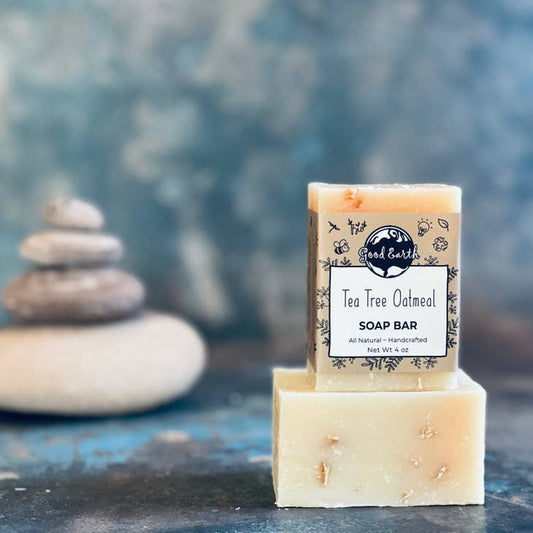 Image of tea tree oatmeal soap bars, one is in zero waste packaging.