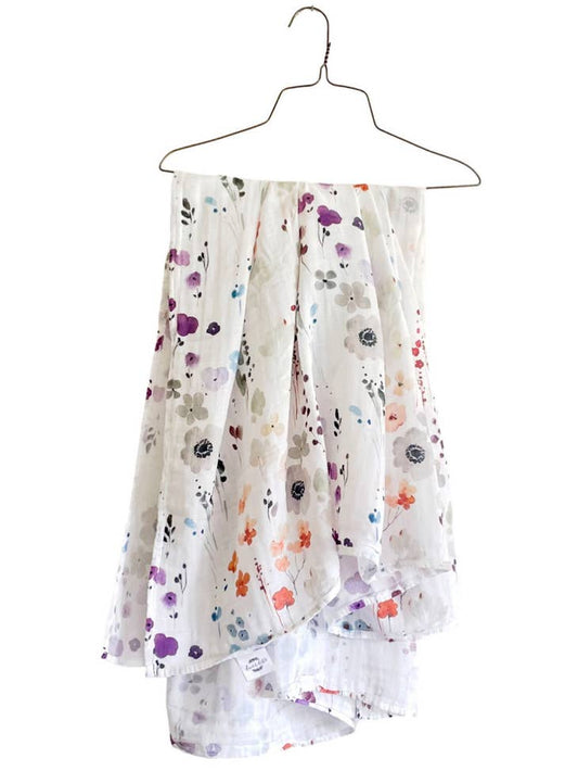 Image of organic cotton muslin blanket on a hanger,  white with floral print