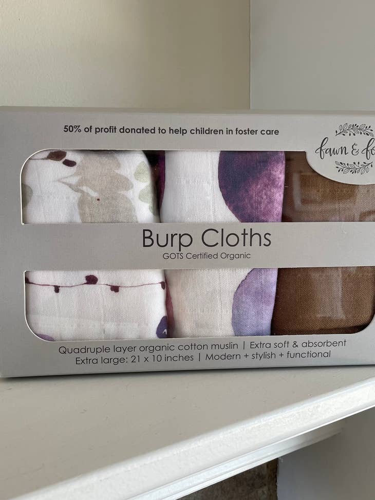 3 pack of organic cotton muslin burp cloths in violet theme in fawn and foster brand packaging. 